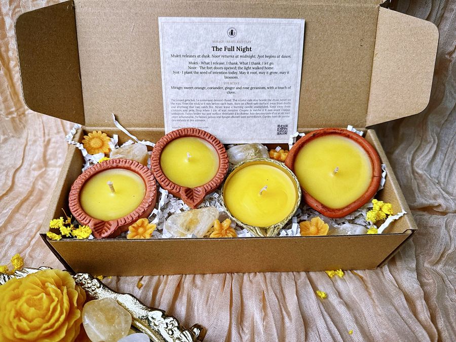 Clay and brass diyas in a kraft gift box with crystals and a story card