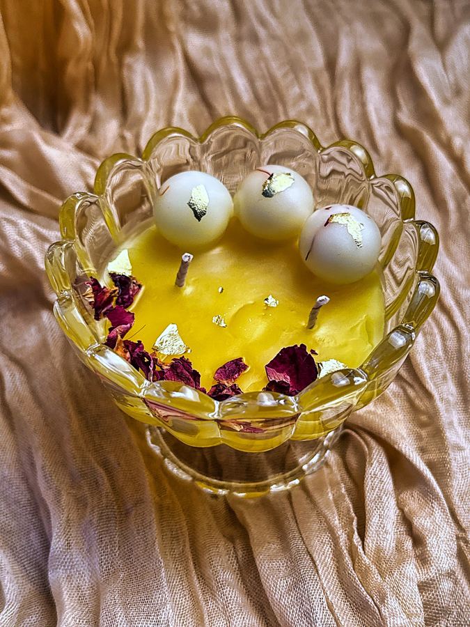 Ras Malai beeswax candle in a glass lotus bowl