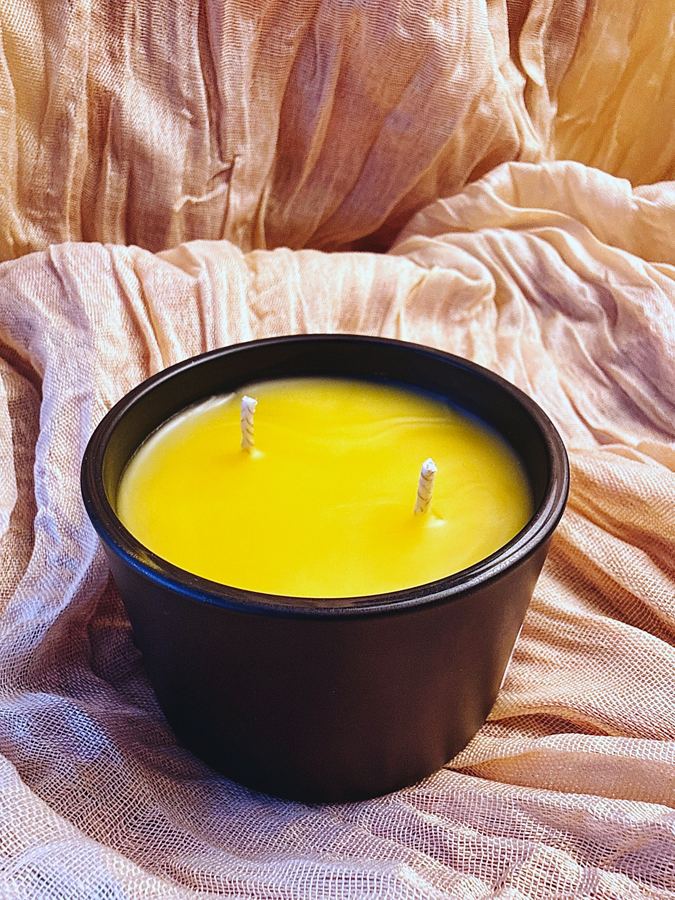 Two-wick beeswax candle in a matte black jar